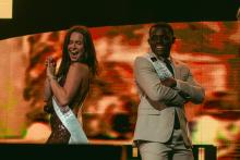 The 2024 Homecoming King and Queen posing onstage at Homecoming Live